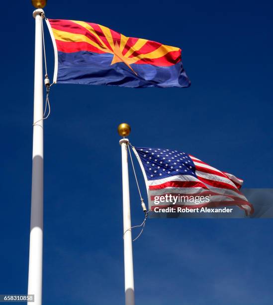 The Arizona state flag flies beside the United States flag at the Visitor Center at Canyon de Chelly National Monument near Chinle, Arizona....