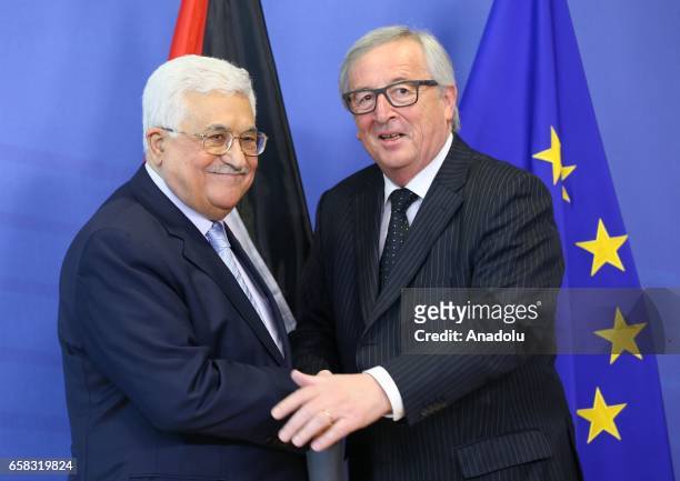 Palestinian President Mahmoud Abbas shakes hands with the President of the European Commission Jean-Claude Juncker in Brussels, Belgium on March 26,...
