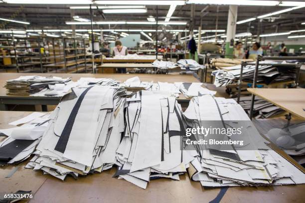 Cut pieces of fabric sit at a table inside the Joseph Abboud Manufacturing Corp. Facility in New Bedford, Massachusetts, U.S., on Wednesday, March...