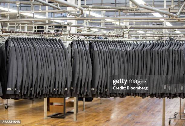 Finished suit jackets hang at the Joseph Abboud Manufacturing Corp. Facility in New Bedford, Massachusetts, U.S., on Wednesday, March 22, 2017. The...