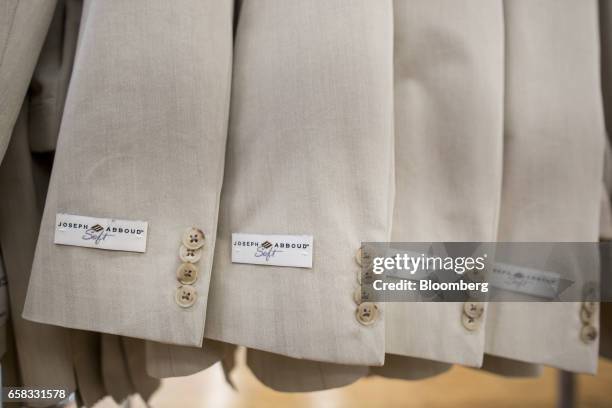 Joseph Abboud Manufacturing Corp. Labels are displayed on the arms of suit jackets at the company's facility in New Bedford, Massachusetts, U.S., on...