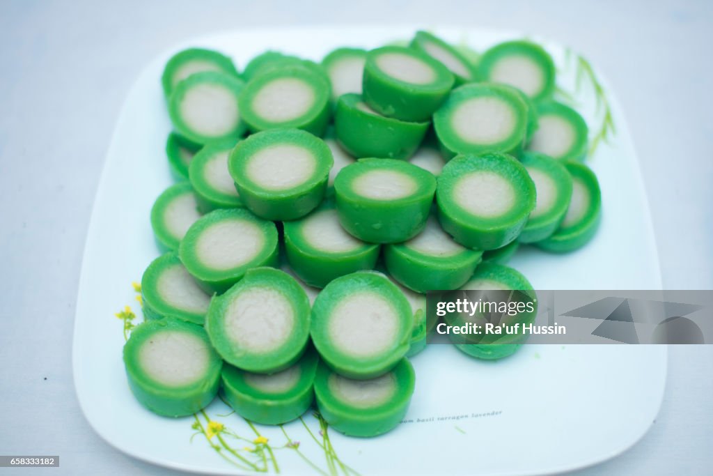 Malaysian food Kuih Nona Manis or Nona Manis Cake, soft steamed pudding with pandan leaves