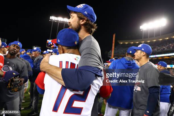 Cleveland Indians teammates Andrew Miller of Team USA and Francisco Lindor of Team Puerto Rico meet on the field after Game 3 of the Championship...