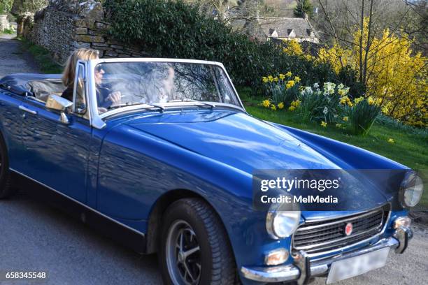 Kate Moss driving her MGB roadster classic car, kitted out with retro fluffy seat covers, back to her home in the Cotswold , on March 25, 2017 in...