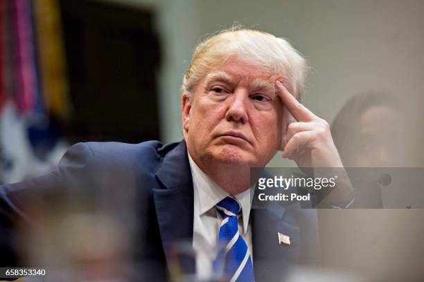 President Donald Trump listens while meeting with women small business owners in the Roosevelt Room of the White House on March 27, 2017 in...