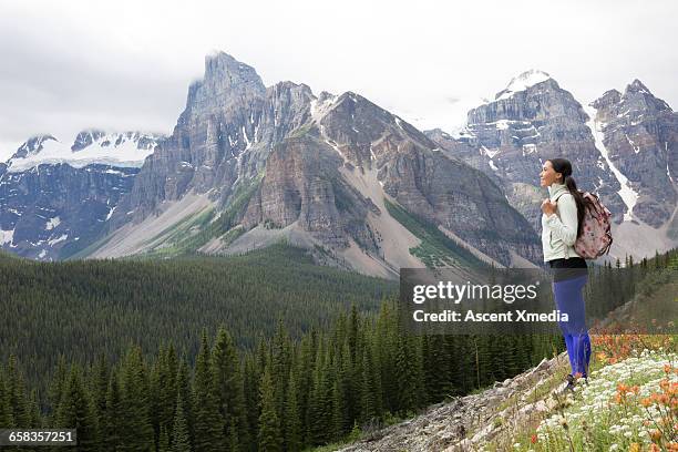 native american woman looks off to mtns from slope - indigenous canada stock pictures, royalty-free photos & images