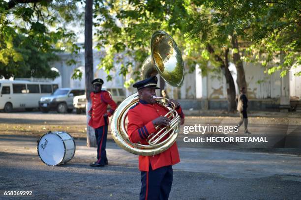 Members of the music band of the Haitian National Palace prepare to give honors to the Chilean President, Michelle Bachelet and Haitian President...