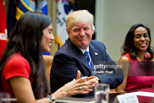 President Donald Trump listens as Dyan Gibbens, founder and chief executive officer of Trumbull Unmanned, speaks during a meeting with women small...