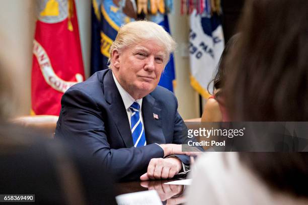 President Donald Trump listens while meeting with women small business owners in the Roosevelt Room of the White House on March 27, 2017 in...