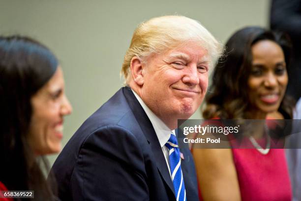 President Donald Trump smiles while meeting with women small business owners in the Roosevelt Room of the White House on March 27, 2017 in...