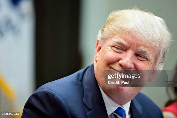 President Donald Trump smiles while meeting with women small business owners in the Roosevelt Room of the White House on March 27, 2017 in...