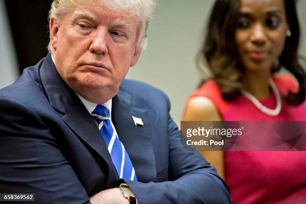 President Donald Trump and Jessica Johnson, president of Johnson Security Bureau Inc., right, listen during a meeting with women small business...