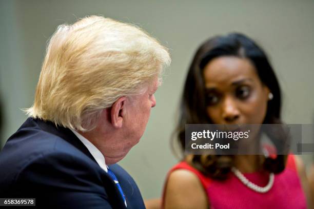 President Donald Trump listens as Jessica Johnson, president of Johnson Security Bureau Inc., right, speaks during a meeting with women small...
