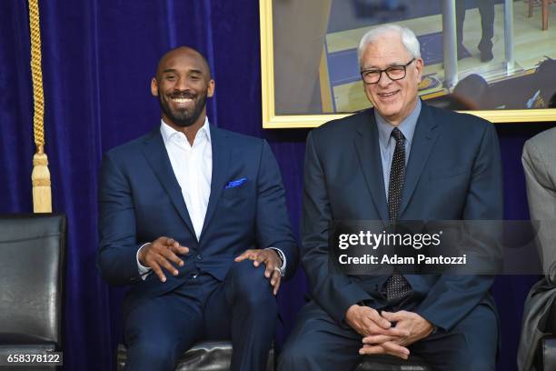 Phil Jackson and Kobe Bryant pose for a photo on stage during the Los Angeles Lakers unveiling of the Shaquille O'Neal statue during an event on...