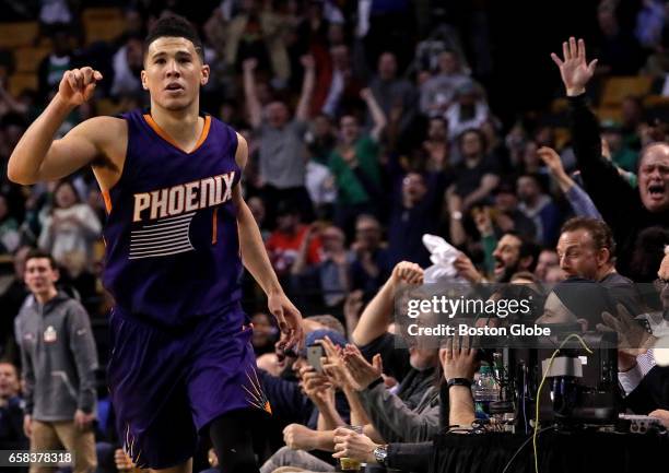 An off-balance three pointer by Phoenix Suns guard Devin Booker brings the Garden fans to their feet and Booker signals it's good for 3 of his 70...