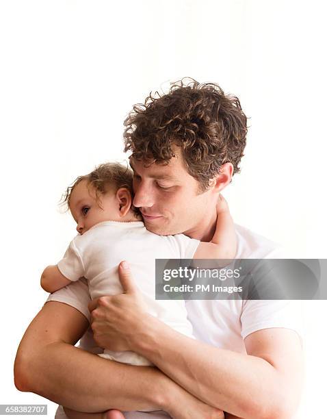 father holding baby girl - baby studio stock pictures, royalty-free photos & images