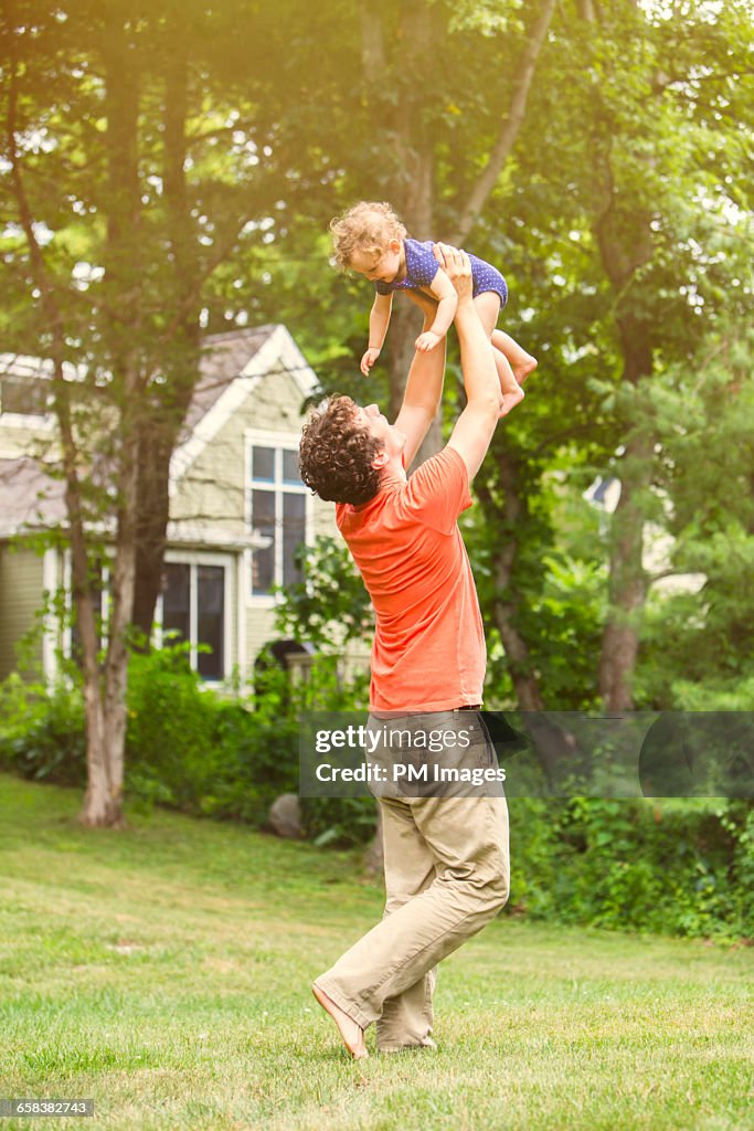 Father playing with baby daughter
