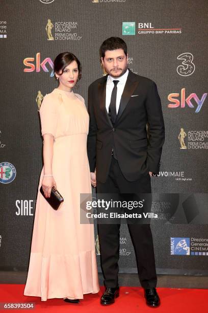 Claudio Giovannesi and a guest walk the red carpet of the 61. David Di Donatello on March 27, 2017 in Rome, Italy.