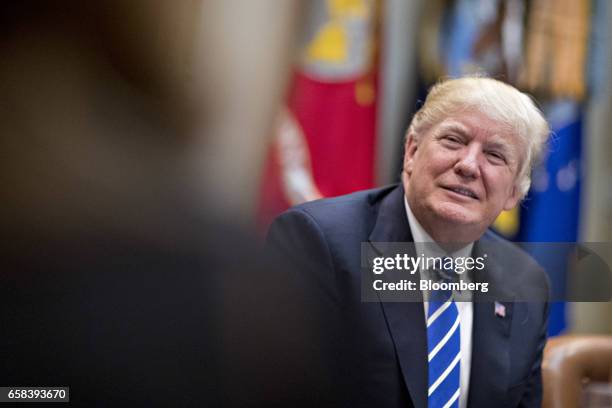 President Donald Trump listens while meeting with women small business owners in the Roosevelt Room of the White House in Washington, D.C., U.S., on...