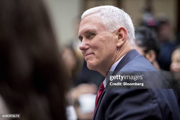 Vice President Mike Pence listens while meeting with U.S. President Donald Trump, not pictured, and women small business owners in the Roosevelt Room...