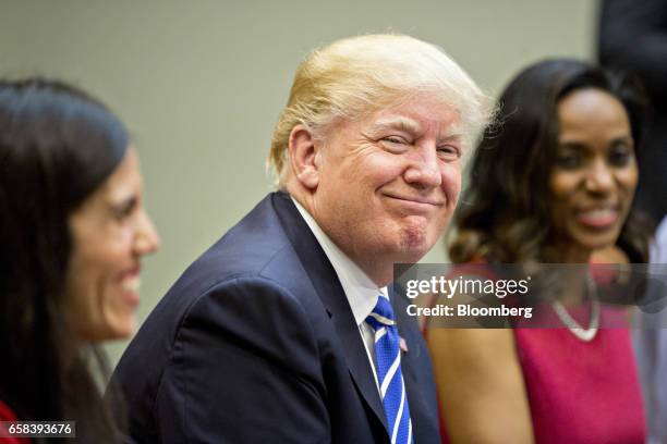 President Donald Trump smiles while meeting with women small business owners in the Roosevelt Room of the White House in Washington, D.C., U.S., on...