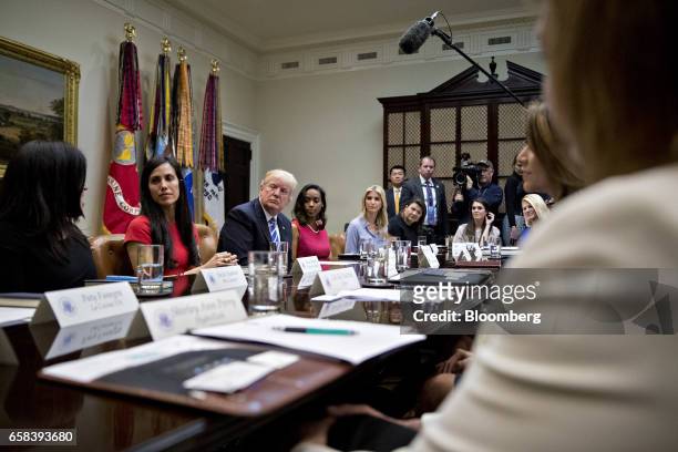President Donald Trump, third left, and daughter Ivanka Trump, center, listen during a meeting with women small business owners in the Roosevelt Room...