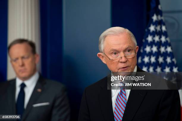 White House Press Secretary Sean Spicer looks on as US Attorney General Jeff Sessions speaks during the Daily Briefing at the White House in...