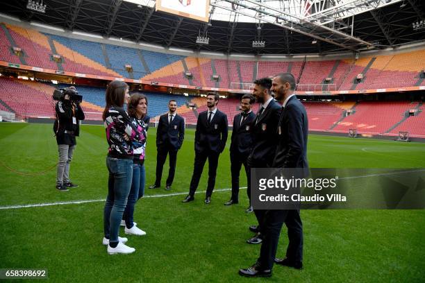 Players of Italy talk with Marta Carissimi and Cecilia Salvai of the Italy women's national football team during a pitch walk about at Amsterdam...
