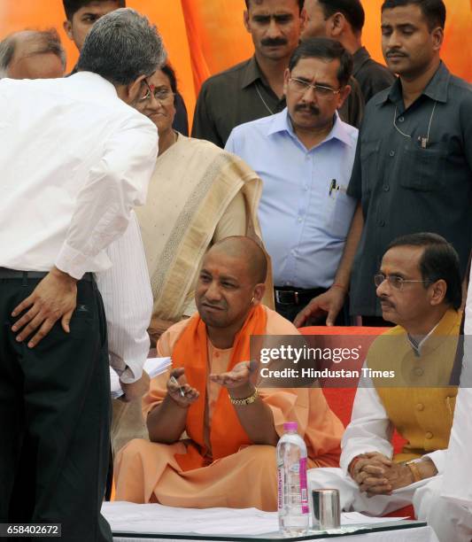 Uttar Pradesh Chief Minister Yogi Adityanath along with Deputy Chief Minister Dinesh Sharma talking to LDA officials during the inspection of Gomti...