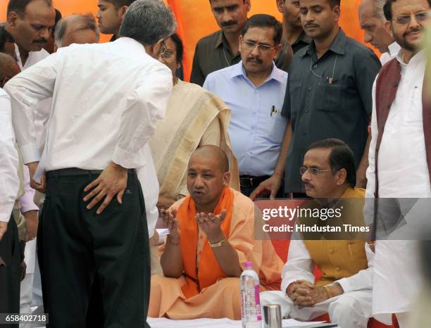 Uttar Pradesh Chief Minister Yogi Adityanath along with Deputy Chief Minister Dinesh Sharma talking to LDA officials during the inspection of Gomti...