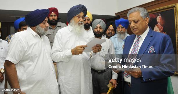 Former Punjab CM Parkash Singh Badal and Sukhbir Singh Badal taking oath in Speaker office at Punjab Vidhan Sabha on March 27, 2017 in Chandigarh,...