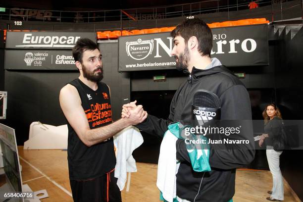 Pierre Oriola, #18 of Valencia Basket greets Daniel Diez, #11 of Unicaja Malaga during the 2016-2017 7DaysEurocup Finals Valencia Basket training...