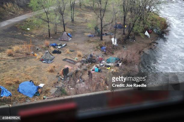Homeless encampment is seen as Amtrak's California Zephyr pulls out of the Denver Union rail station during its daily 2,438-mile trip to...
