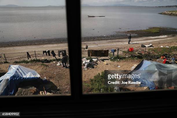 Homeless encampment is seen as Amtrak's California Zephyr passes along San Pablo Bay as it comes close to the end of its daily 2,438-mile trip to...