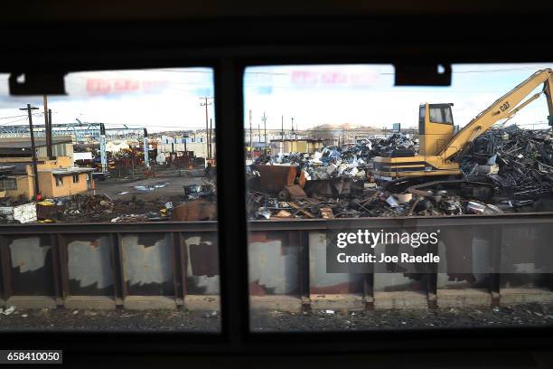 Amtrak's California Zephyr rolls past a metal salvage yard as it arrives into a train station during its daily 2,438-mile trip to Emeryville/San...