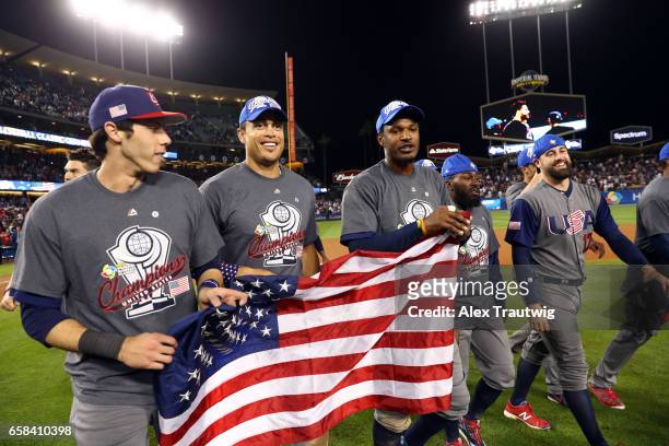 Christian Yelich, Giancarlo Stanton and Adam Jones of Team USA celebrate on field after winning Game 3 of the Championship Round of the 2017 World...