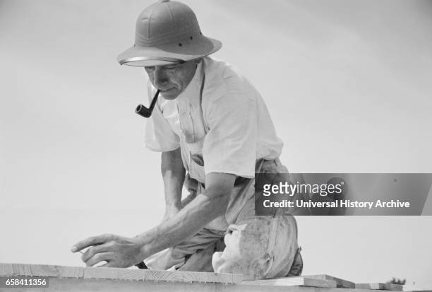 Carpenter Working in Model Community Planned by Suburban Division of U.S. Resettlement Administration, Greenbelt, Maryland, USA, Carl Mydans for U.S....