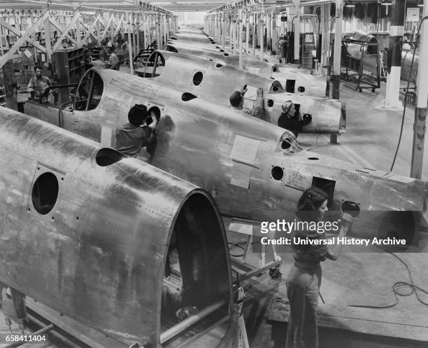 Workers on P-51 Fuselage Overhead Conveyor Line, North American Aviation Plant, Inglewood, California, USA, Alfred T. Palmer for Office of War...
