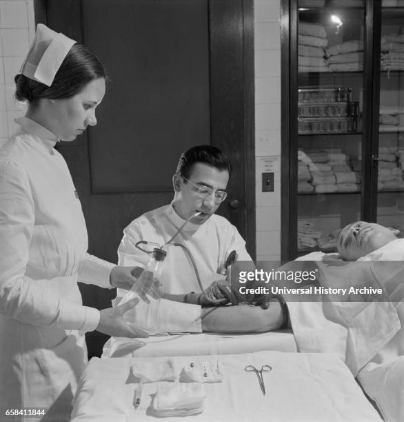 Nurse Assisting Doctor with Blood Transfusion, Fritz Henle for Office of War Information, November 1942.