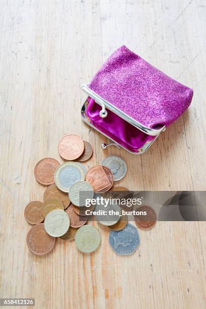 high angle view of british pound coins with wallet - brieftasche stock-fotos und bilder