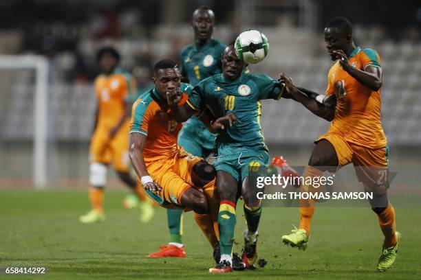 Senegal's forward Sadio Mane vies with Ivory Coast's defender Simon Deli and Ivory Coast's defender Eric Bailly during the friendly football match...