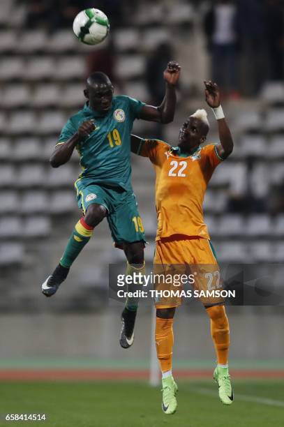 Senegal's defender Saliou Ciss and Ivory Coast's defender Mamadou Bagayoko jump for the ball during the friendly football match Ivory Coast vs...