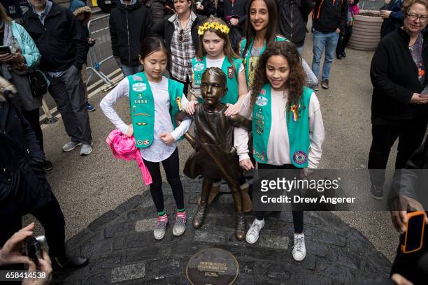 Young members of Girl Scout troop 3484 pose for photos with the 'Fearless Girl' statue, March 27, 2017 in New York City. New York City Mayor Bill De...