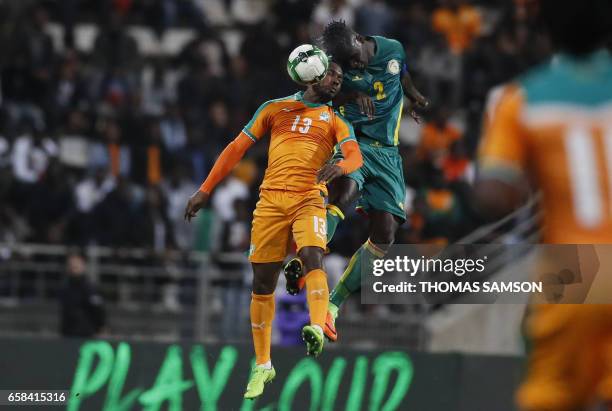 Ivory Coast's forward Giovanni Sio vies with Senegal's defender Kara Mbodji during the friendly football match Ivory Coast vs Senegal, on March 27 at...