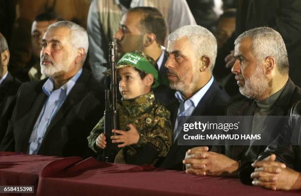 Yahya Sinwar , the new leader of the Hamas Islamist movement in the Gaza Strip and senior political leader Ismail Haniyeh sit next to the son of...