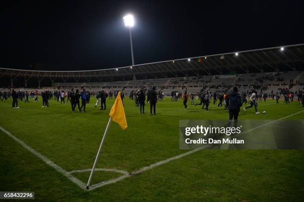 Spectators flood the pitch after the referee abandons the match due to repeated pitch invasions during the International Friendly match between the...