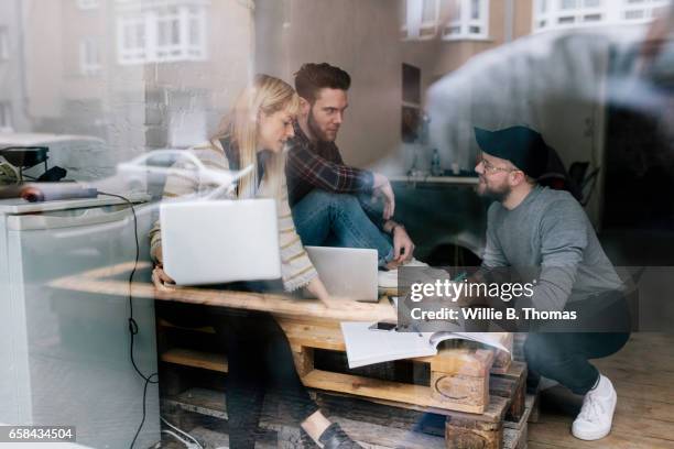 casual business meeting in new office space - glass magazine stock-fotos und bilder