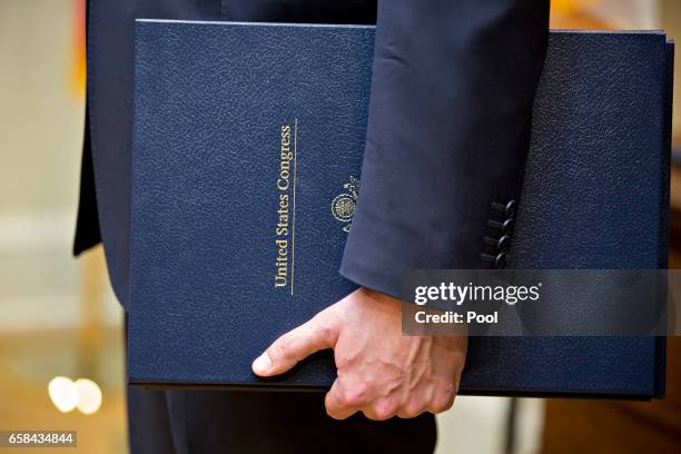 Bills are held before being signed by U.S. President Donald Trump, in the Roosevelt Room of the White HouseMarch 27, 2017 in Washington, D.C. Trump...