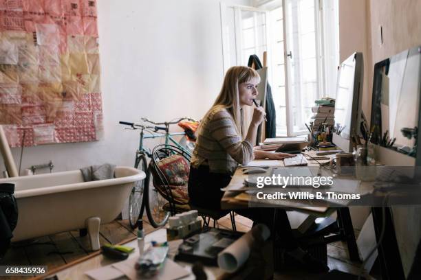 young creative woman working on computer - messy room stock pictures, royalty-free photos & images