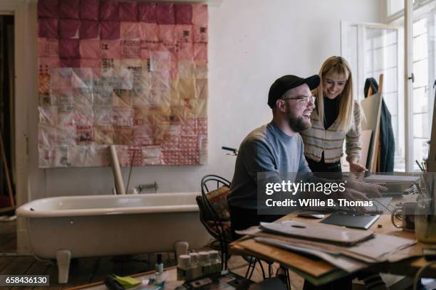 two creatives working in their unfinished office - small office stock pictures, royalty-free photos & images